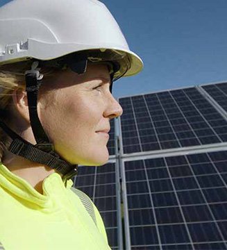 worker infront of solar panels